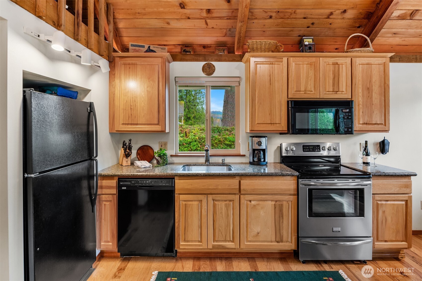 19110 Sulfur Springs Road Mount Vernon, WA 98274 - Photo 14 of 33 a kitchen with stainless steel appliances granite countertop a stove a sink and a refrigerator