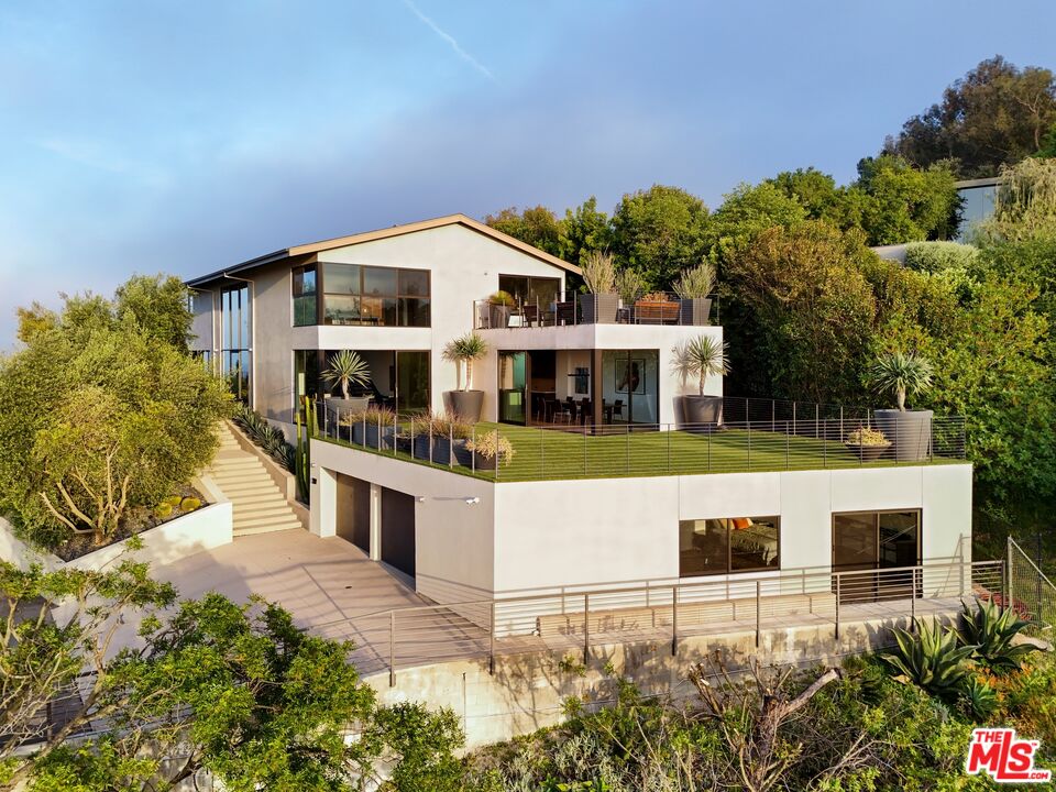 a view of house with a swimming pool