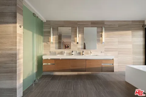 a bathroom with a sink a mirror and a bathtub