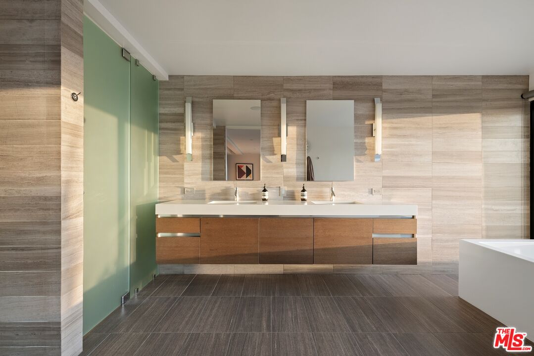 3337 Beverly Ranch Road Beverly Hills, CA 90210 - Photo 13 of 39 a bathroom with a sink a mirror and a bathtub