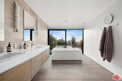 a large white kitchen with a large window