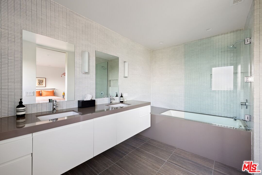 3337 Beverly Ranch Road Beverly Hills, CA 90210 - Photo 19 of 39 a bathroom with a double vanity sink and mirror