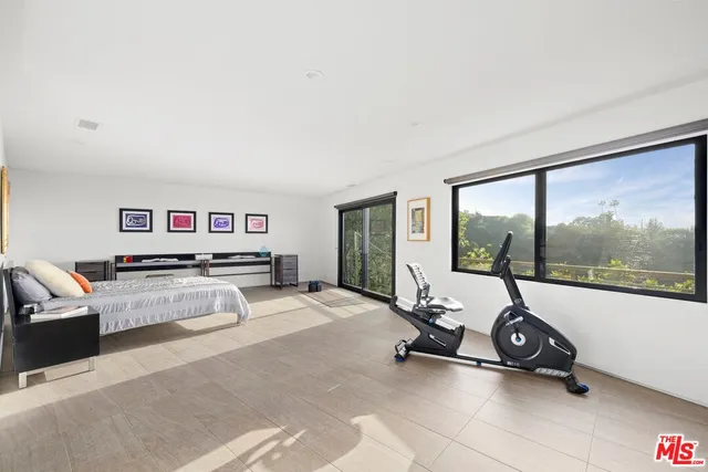 a room with gym equipment and a large window