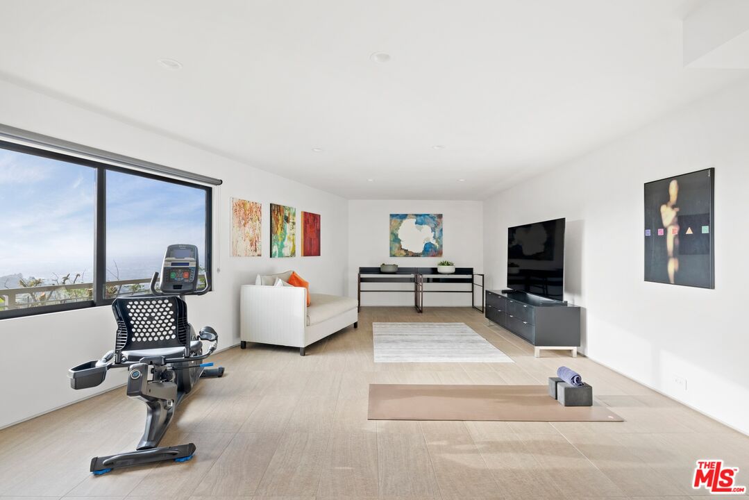 3337 Beverly Ranch Road Beverly Hills, CA 90210 - Photo 27 of 39 a living room with furniture and a flat screen tv