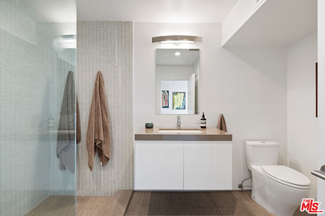 3337 Beverly Ranch Road Beverly Hills, CA 90210 - Photo 28 of 39 a bathroom with a toilet sink and mirror