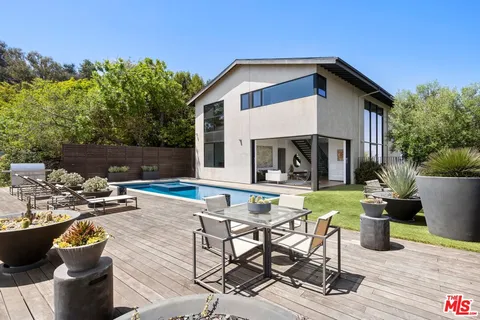 a view of house with backyard outdoor seating and green space