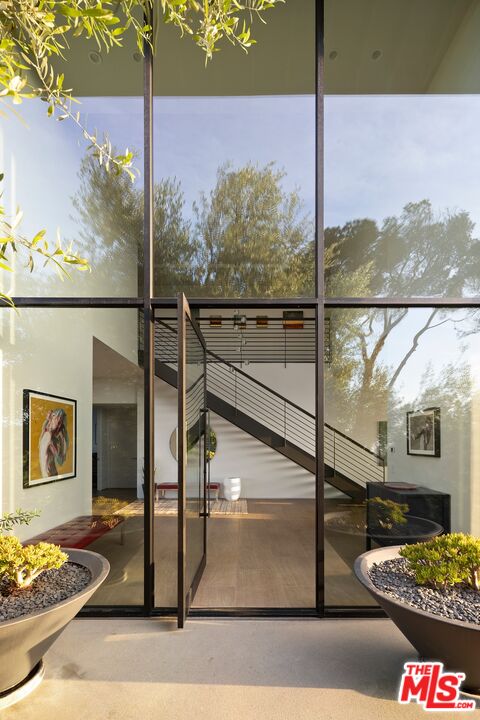 3337 Beverly Ranch Road Beverly Hills, CA 90210 - Photo 4 of 39 a picture of a glass door with a tree in the background