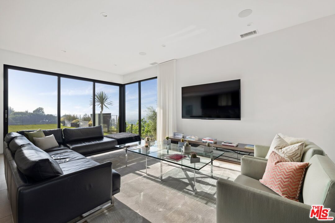 3337 Beverly Ranch Road Beverly Hills, CA 90210 - Photo 7 of 39 a living room with furniture and a flat screen tv