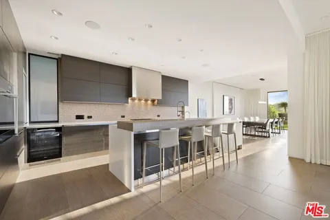 a large white kitchen with a large window