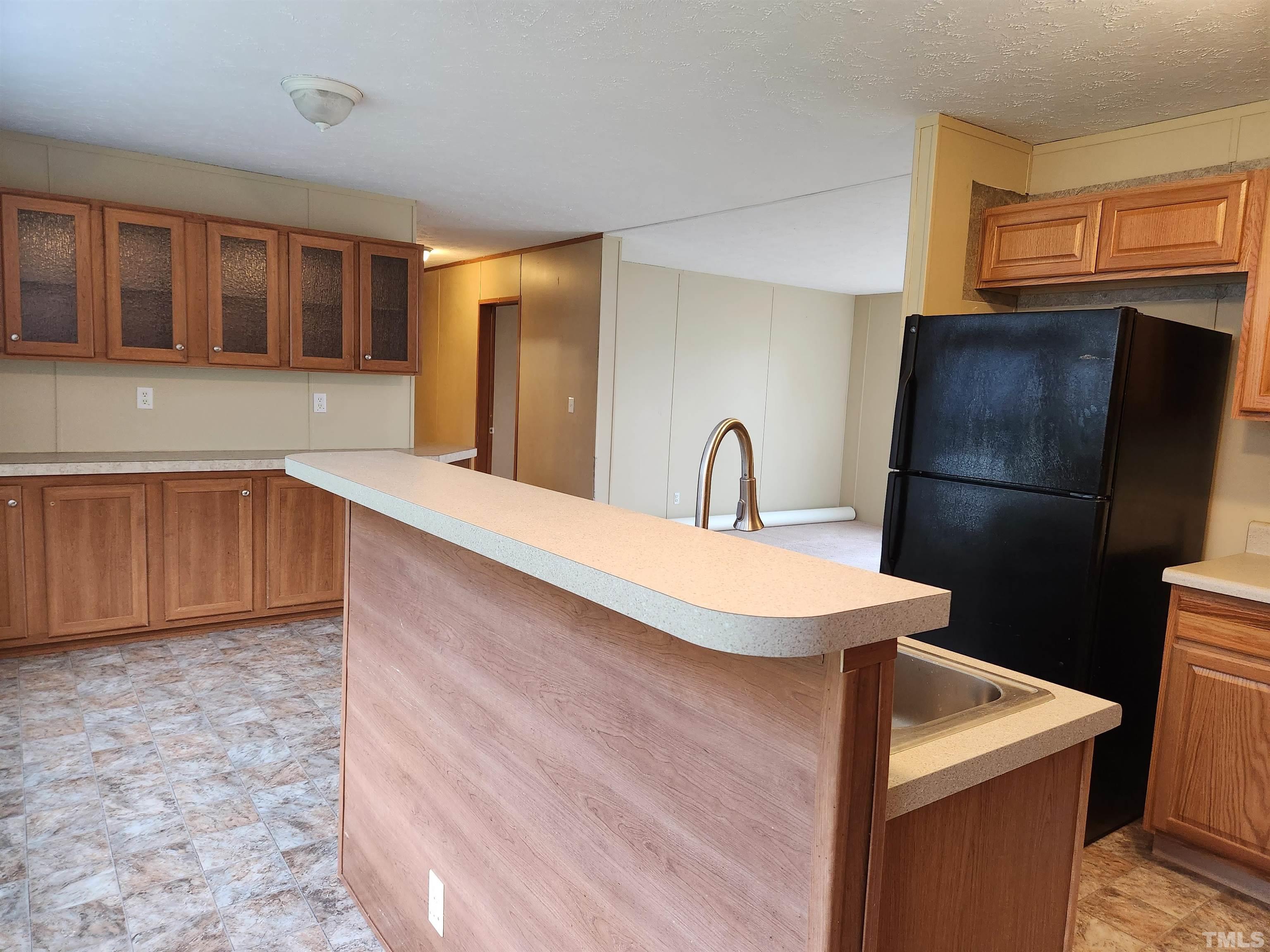 555 Massengill Pond Road Angier, NC 27501 - Photo 14 of 36 a kitchen with stainless steel appliances a refrigerator and a sink