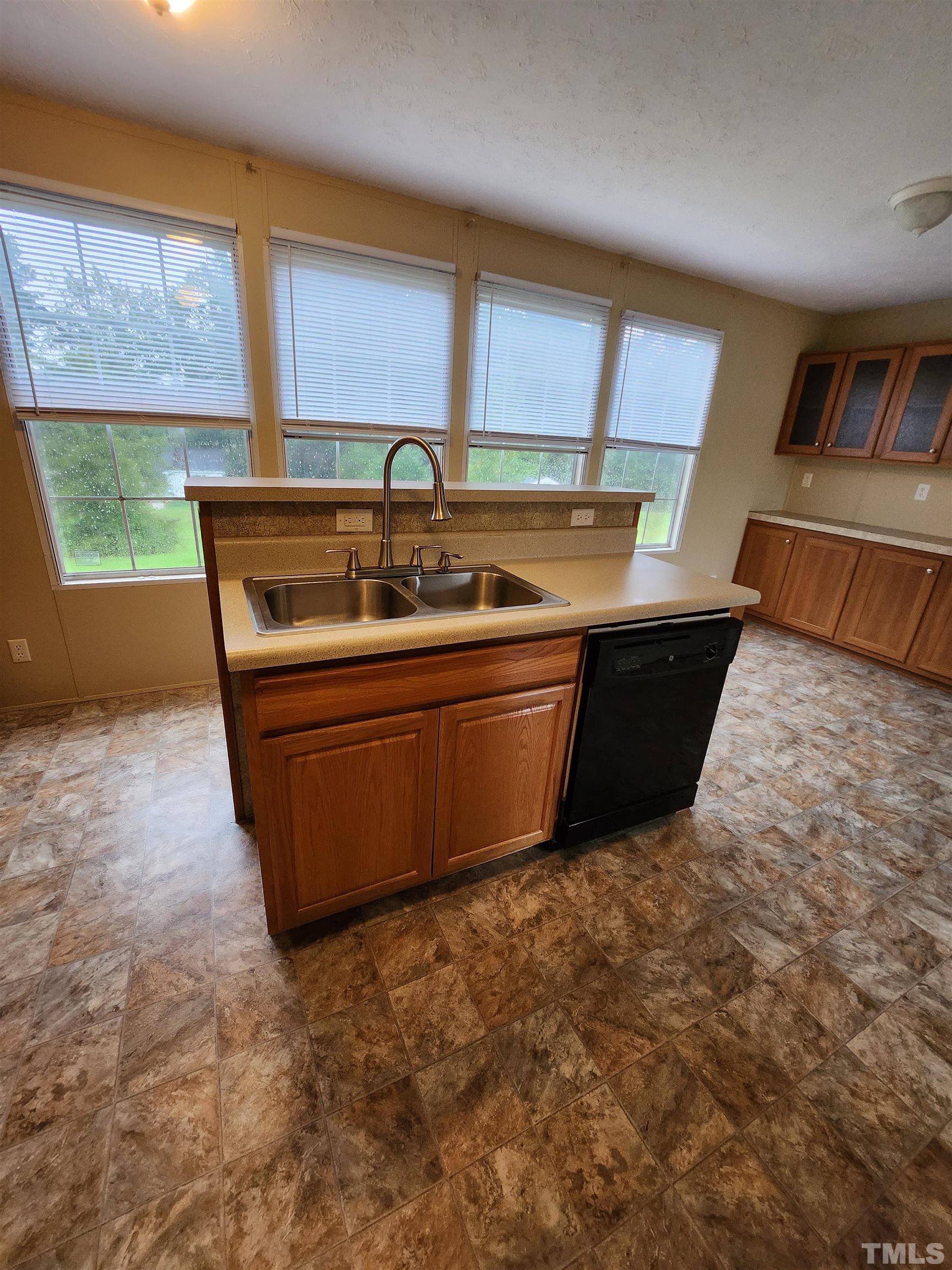 555 Massengill Pond Road Angier, NC 27501 - Photo 16 of 36 a kitchen with sink a window and cabinets