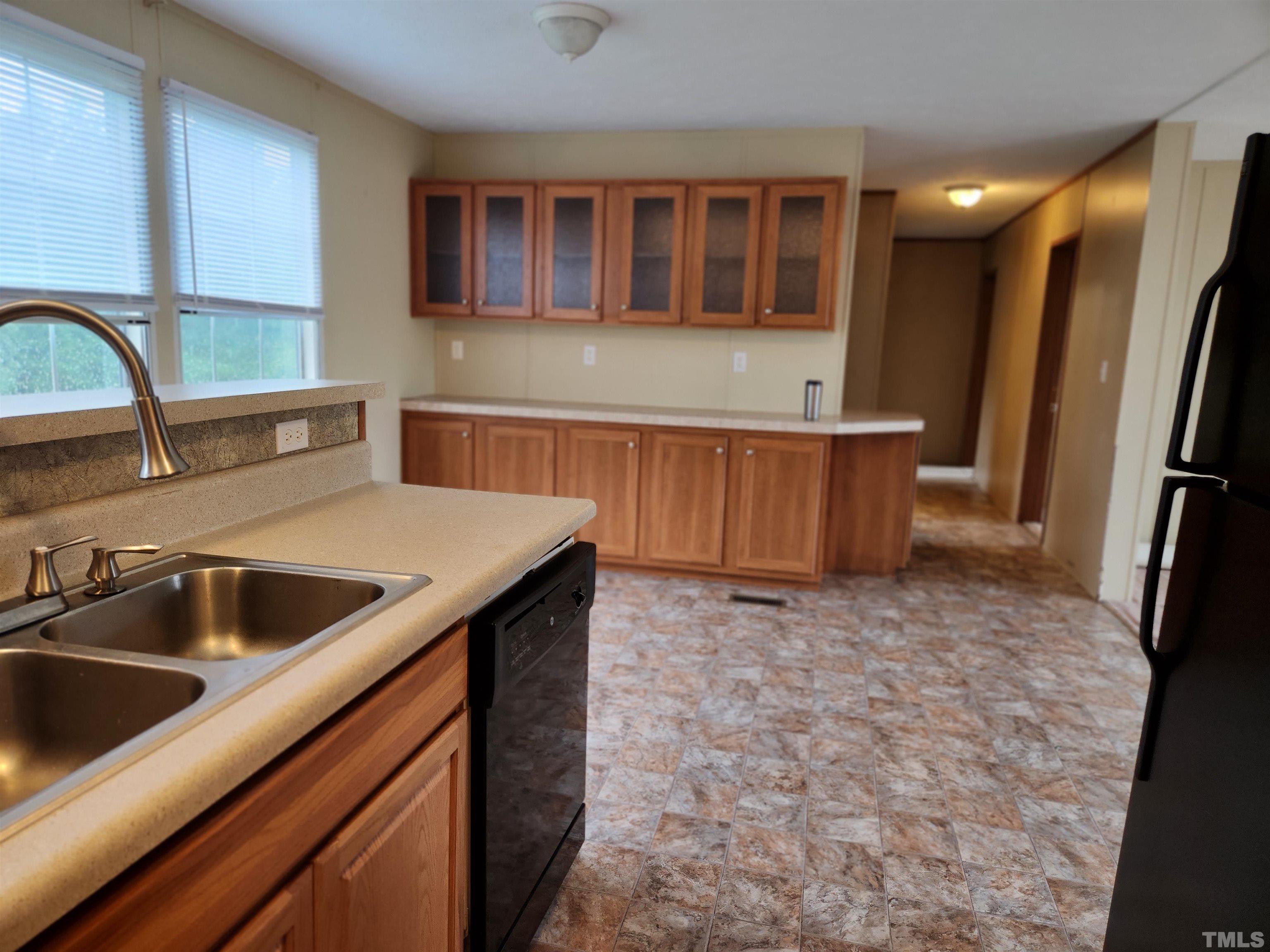 555 Massengill Pond Road Angier, NC 27501 - Photo 18 of 36 a kitchen with a sink and a refrigerator
