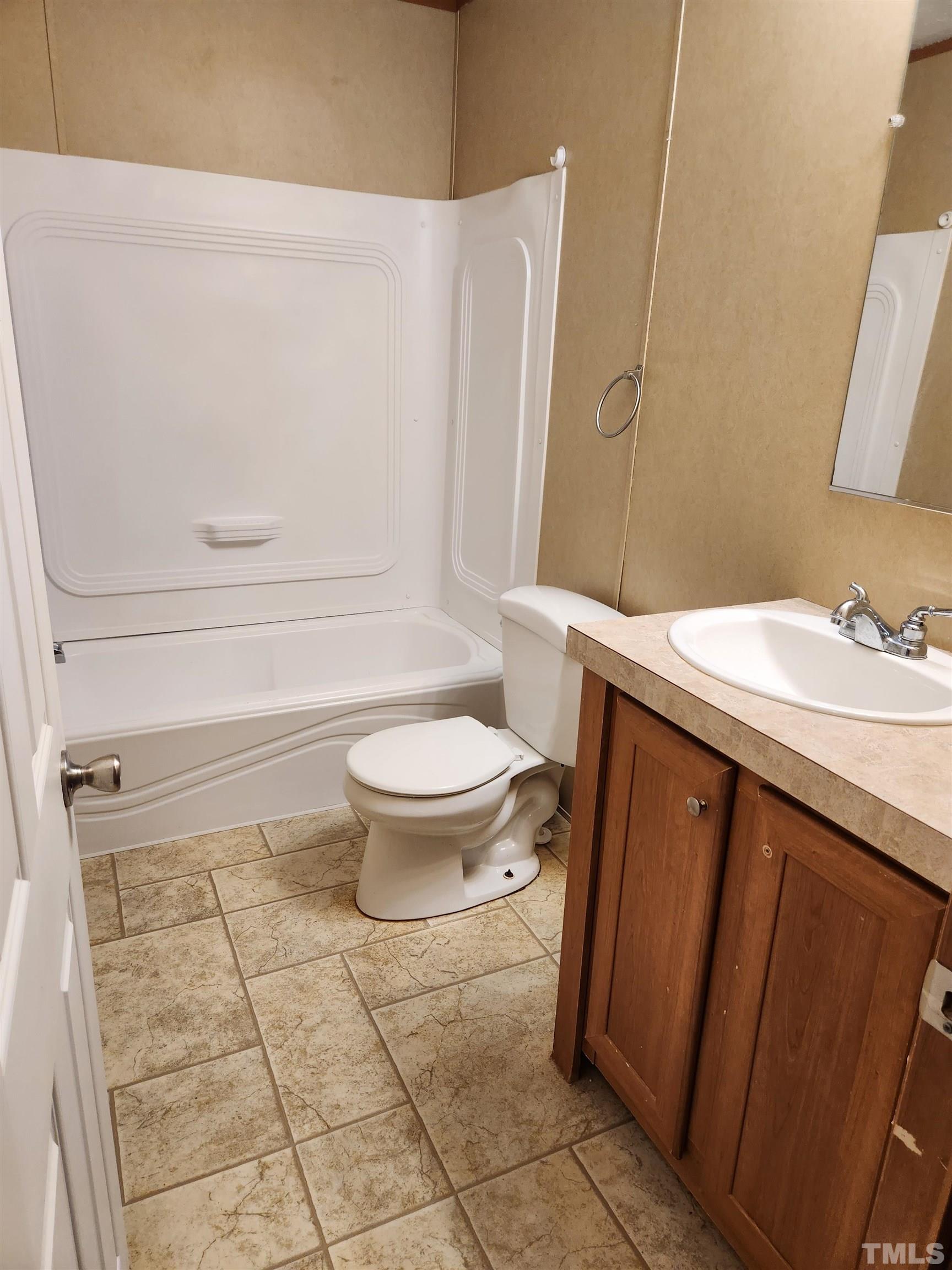 555 Massengill Pond Road Angier, NC 27501 - Photo 26 of 36 a bathroom with a sink a toilet and a mirror