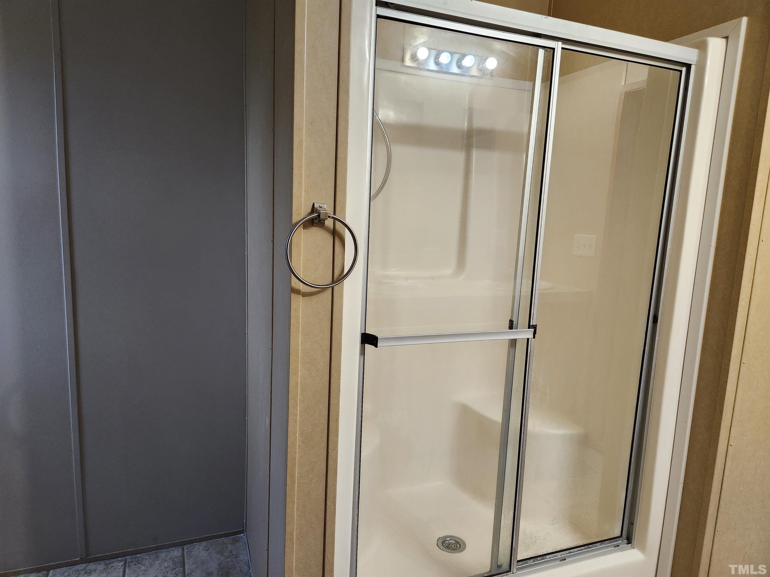 555 Massengill Pond Road Angier, NC 27501 - Photo 28 of 36 a bathroom with a glass shower door