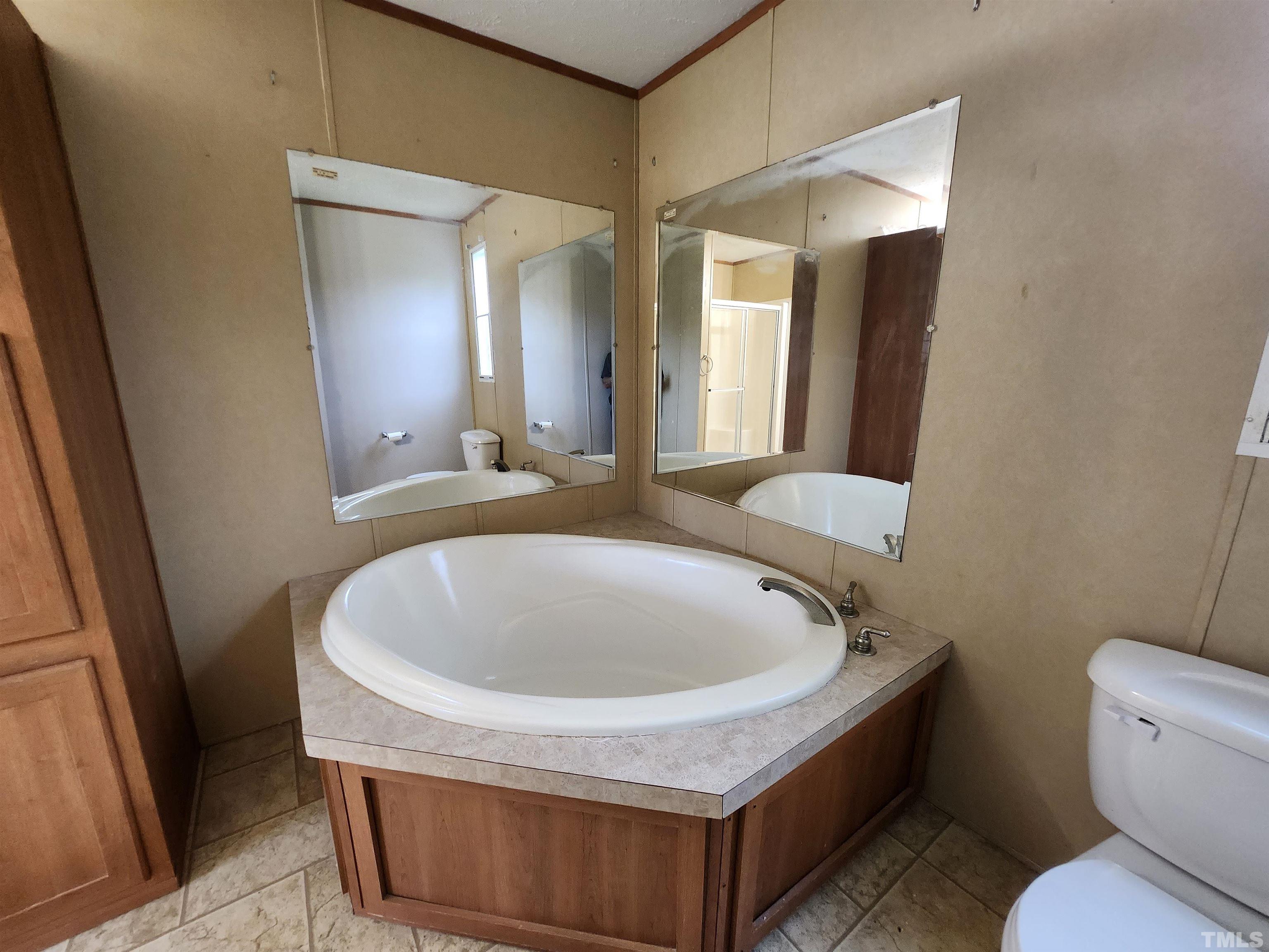 555 Massengill Pond Road Angier, NC 27501 - Photo 31 of 36 a bathroom with a toilet sink and mirror