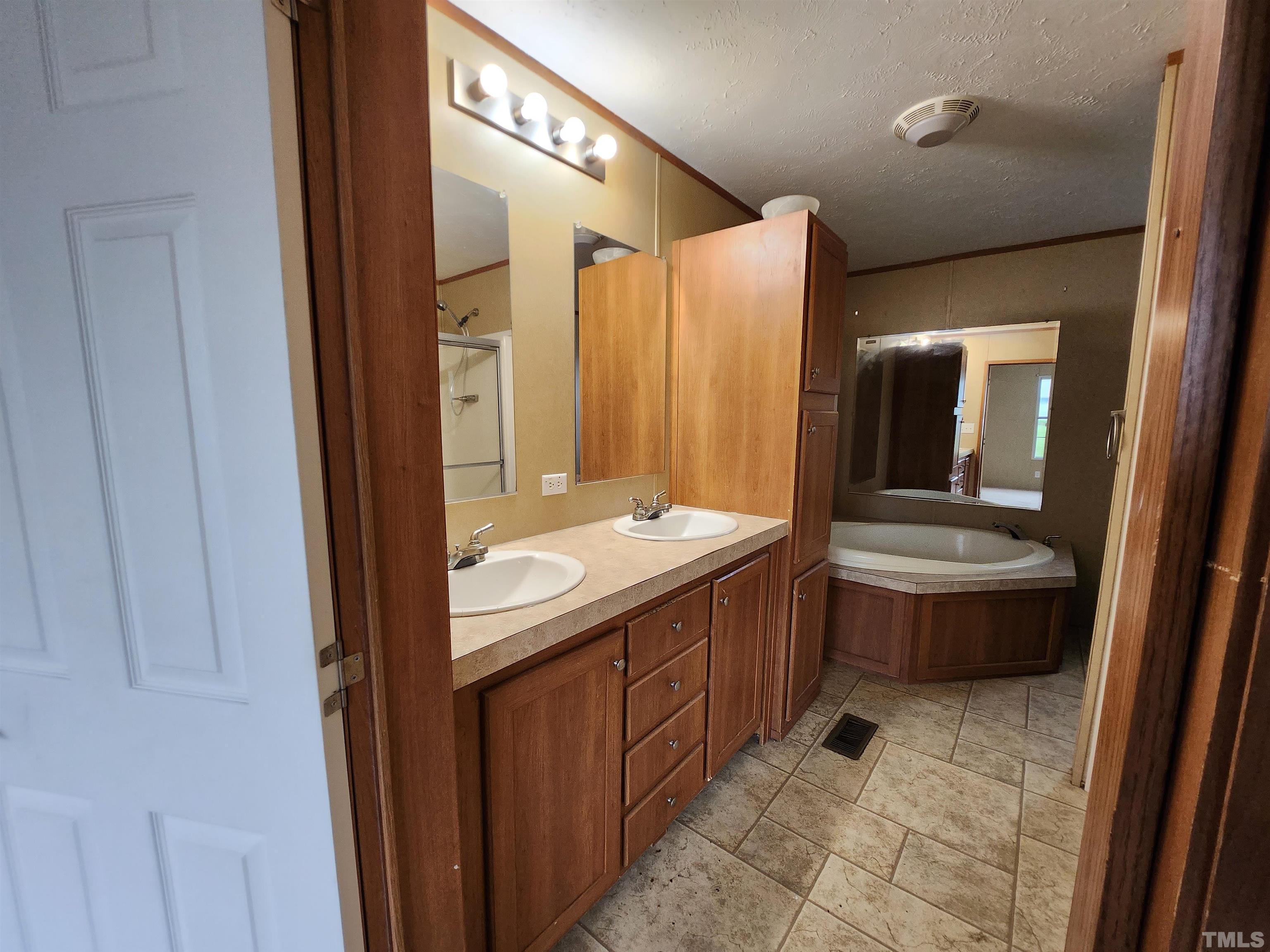 555 Massengill Pond Road Angier, NC 27501 - Photo 32 of 36 a bathroom with a sink a mirror and a toilet
