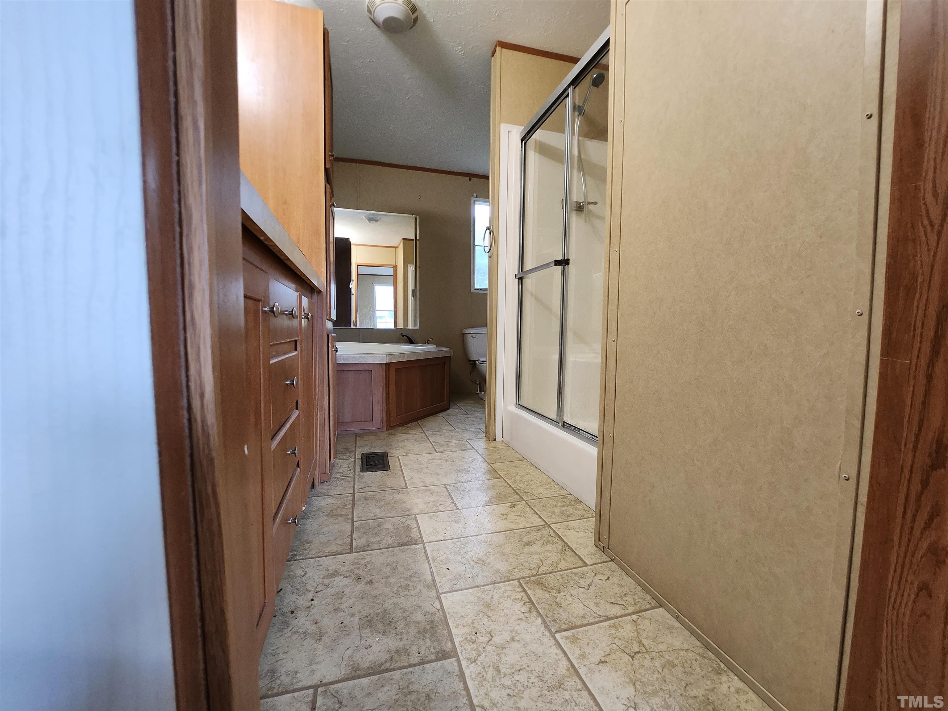 555 Massengill Pond Road Angier, NC 27501 - Photo 33 of 36 a view of a refrigerator in kitchen and an empty room