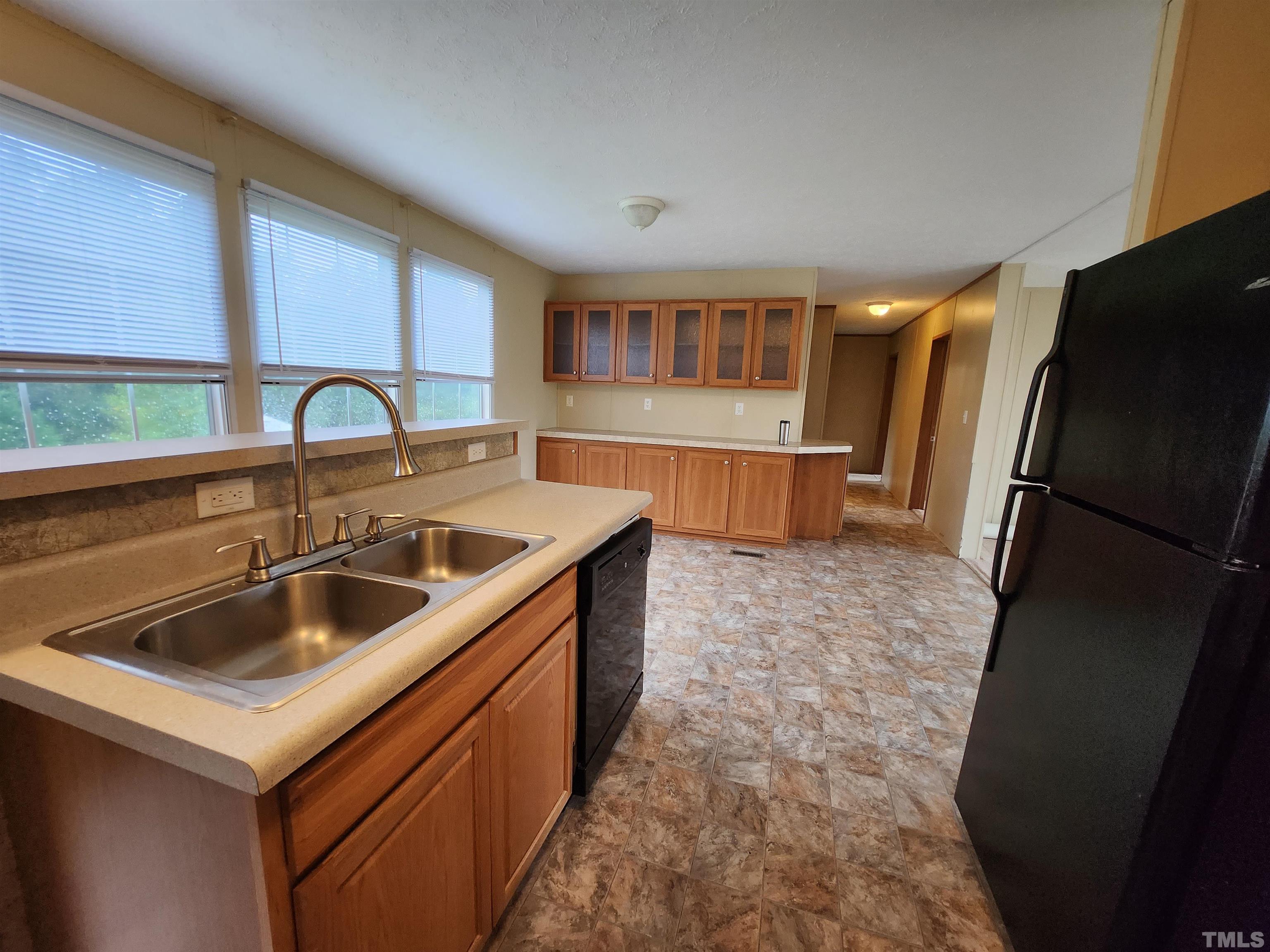 555 Massengill Pond Road Angier, NC 27501 - Photo 35 of 36 a kitchen that has a sink and a refrigerator
