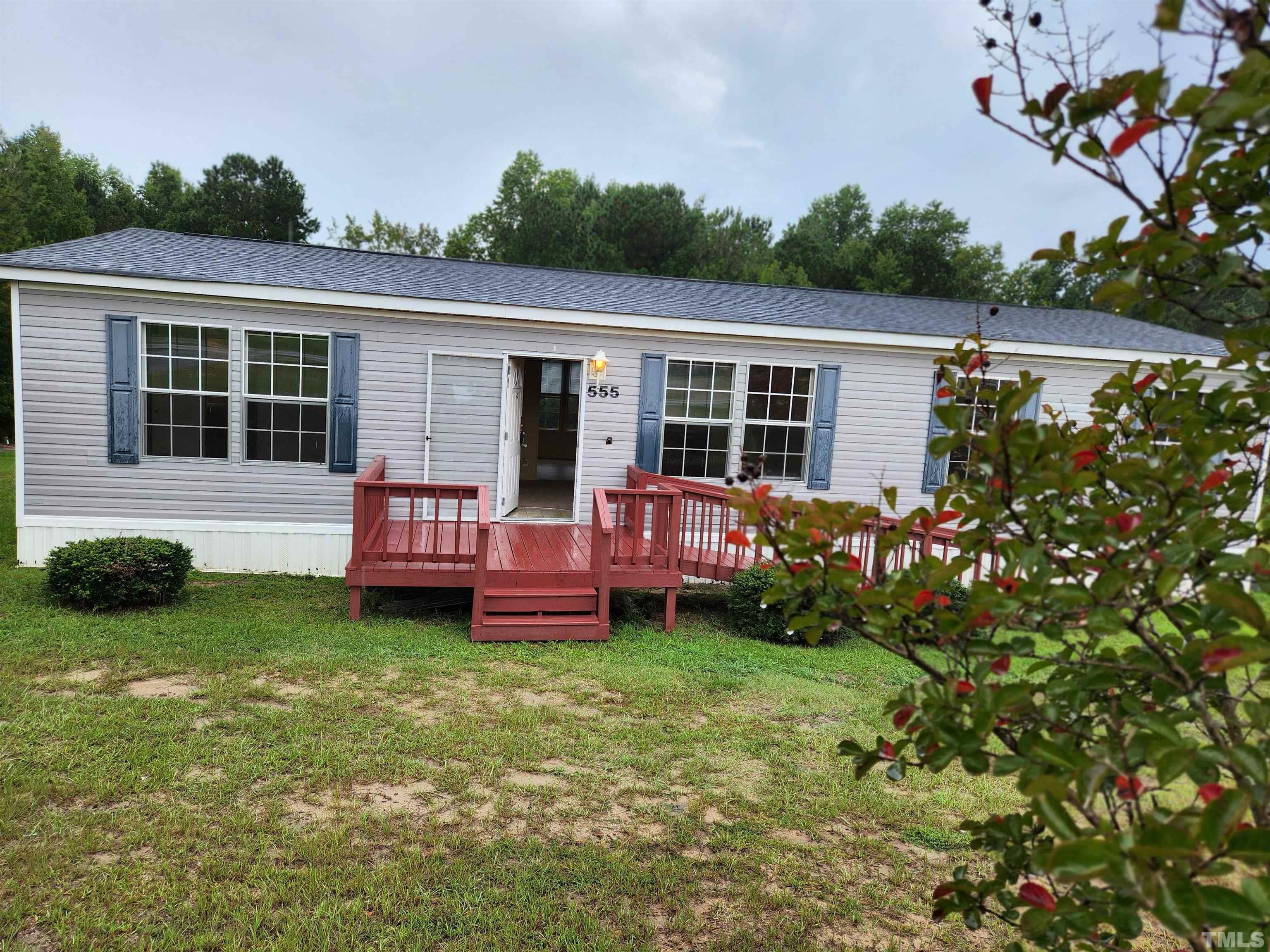 555 Massengill Pond Road Angier, NC 27501 - Photo 4 of 36 a view of a house with a backyard and a patio