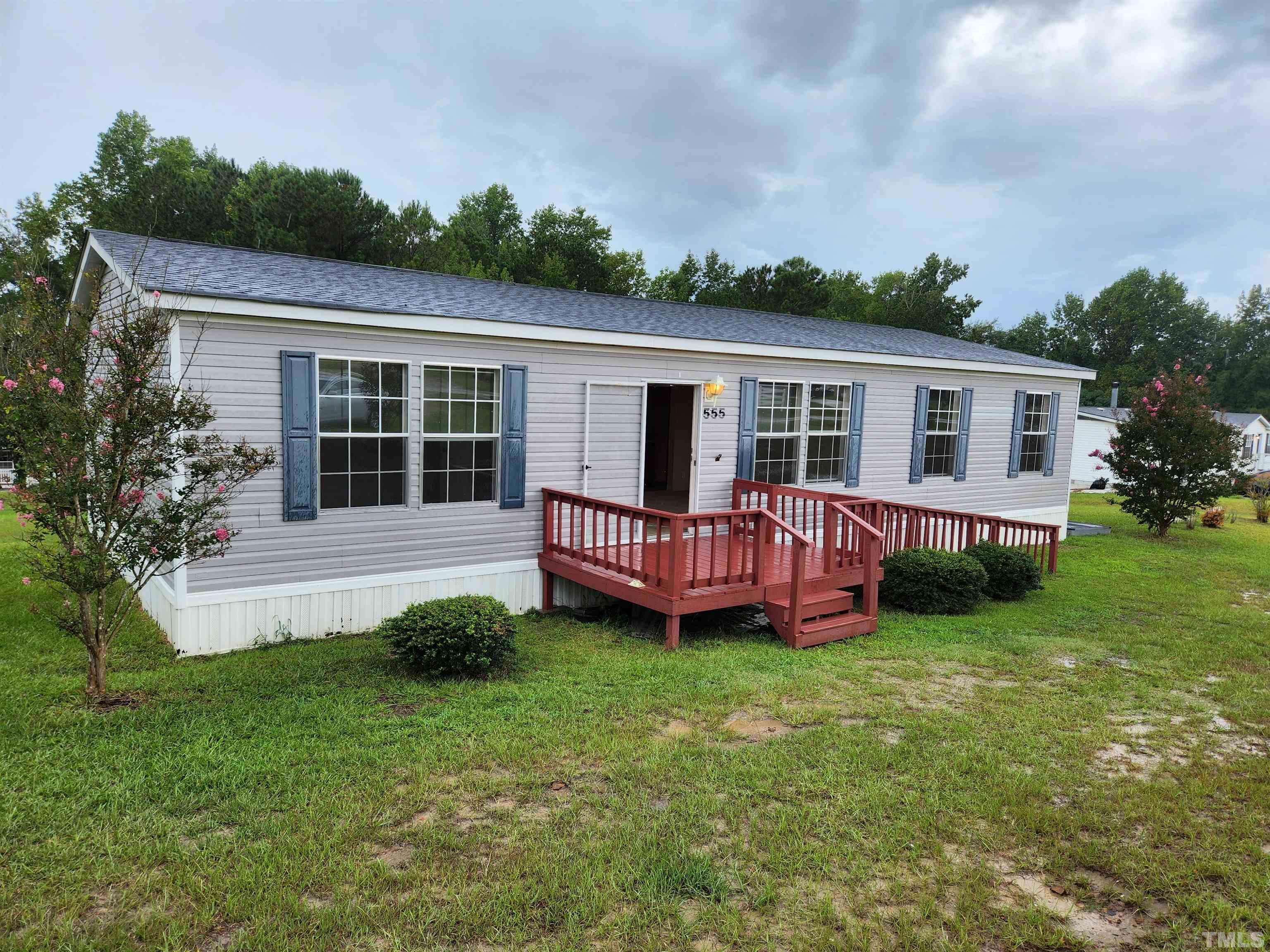 555 Massengill Pond Road Angier, NC 27501 - Photo 5 of 36 a view of a house with a backyard and deck