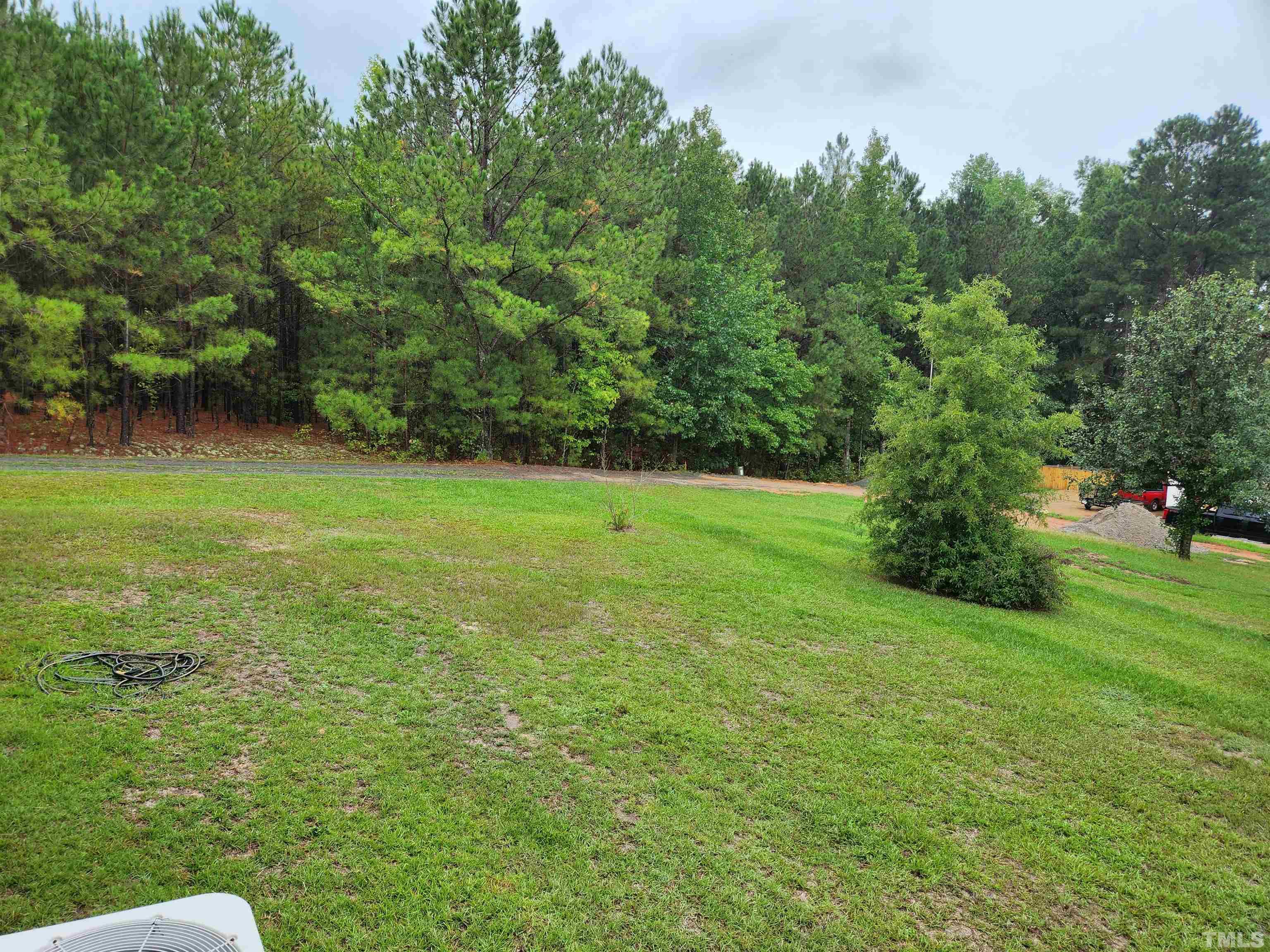 555 Massengill Pond Road Angier, NC 27501 - Photo 8 of 36 a view of a grassy field with trees