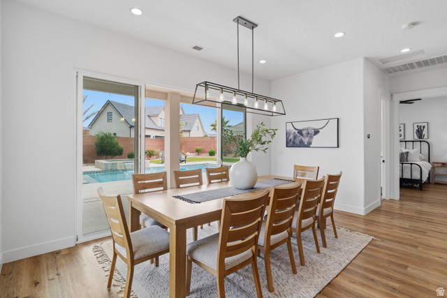 2278 Tawny Ridge Circle St. George, UT 84790 - Photo 16 of 61 Spacious dining area featuring wood-finish flooring and a contemporary linear chandelier.
