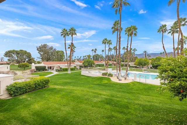 a kitchen that has a sink and a stove with white walls