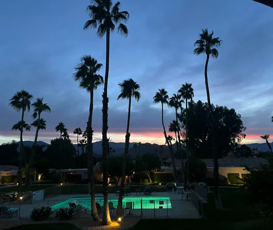 an aerial view of a house with a yard and lake view