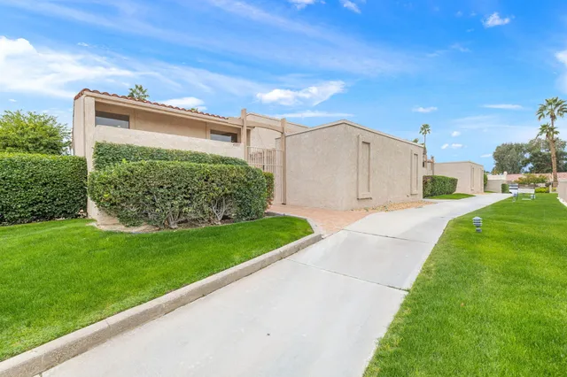a view of a garden with a table and chairs