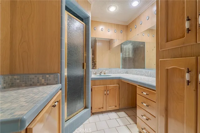 a spacious bathroom with a granite countertop sink and a mirror