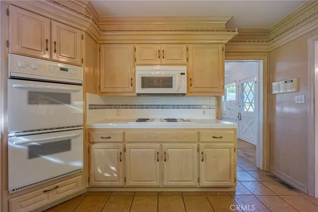 a kitchen with stainless steel appliances granite countertop a stove and a microwave