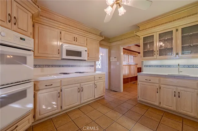 a kitchen with granite countertop cabinets stainless steel appliances and a counter space