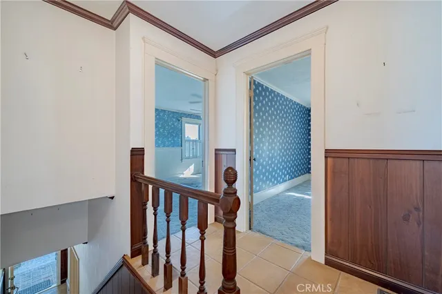 a view of a hallway with wooden floor and entryway