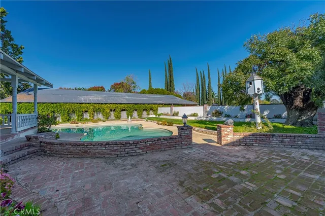 a view of a swimming pool with a yard