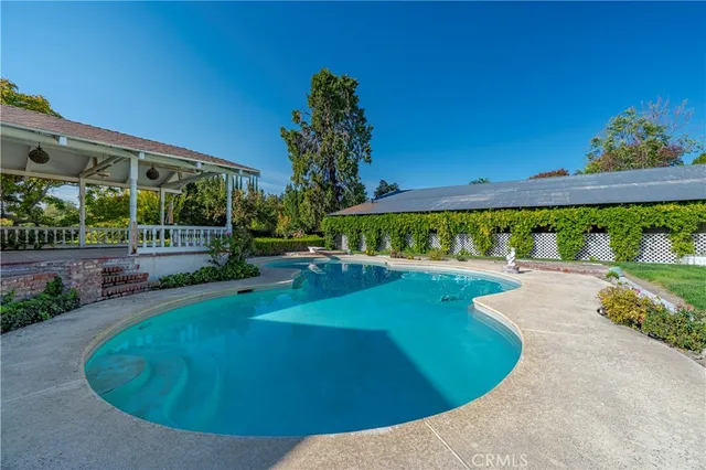 a view of a swimming pool with a patio