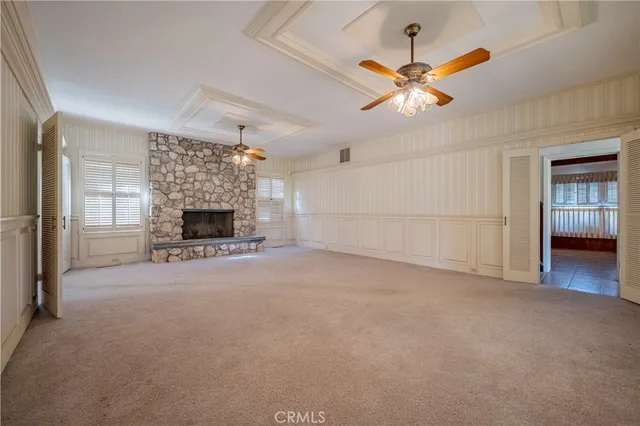 a view of empty room with a ceiling fan and fan
