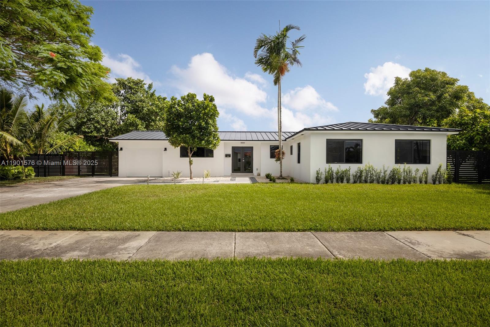 a front view of a house with a garden and yard