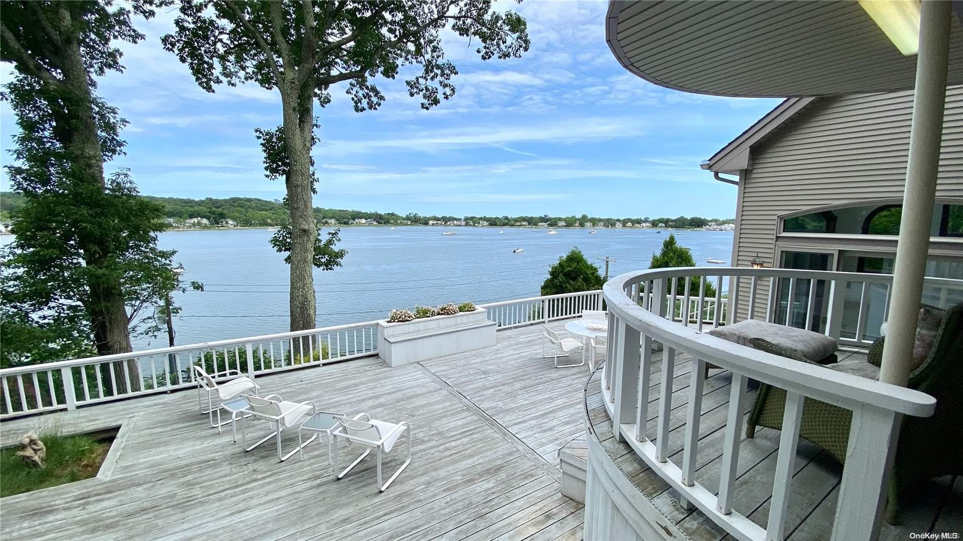 a view of a balcony with lake view and wooden floor