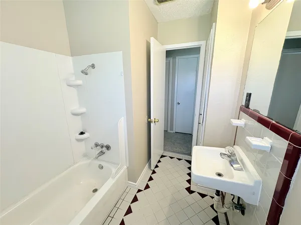 a bath room with a sink and a bath tub
