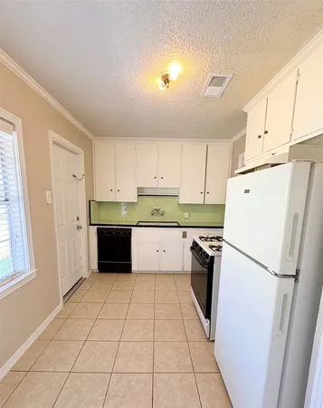 a kitchen with stainless steel appliances a refrigerator sink and cabinets