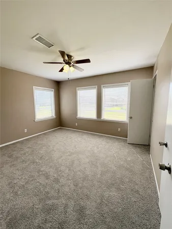 a view of a livingroom with a ceiling fan and window