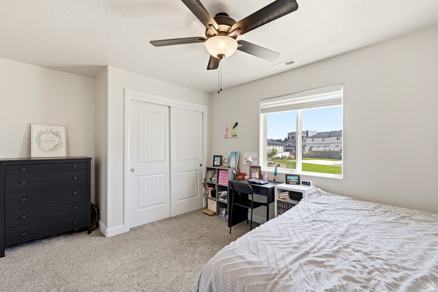 668 East Fiddlers Canyon Road, Unit 6 Cedar City, UT 84721 - Photo 20 of 36 Bedroom featuring a ceiling fan with integrated lighting, a double-panel sliding closet, and a large window