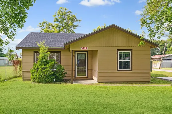 a view of a house with a small yard