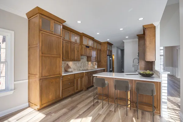 a kitchen with stainless steel appliances granite countertop a refrigerator and a sink