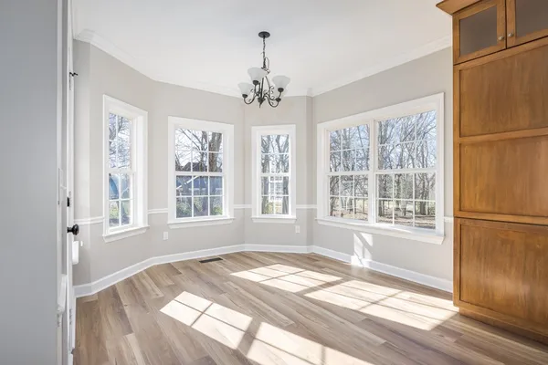 a spacious bedroom with a bed and windows