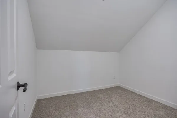 a view of walk in closet with clothes