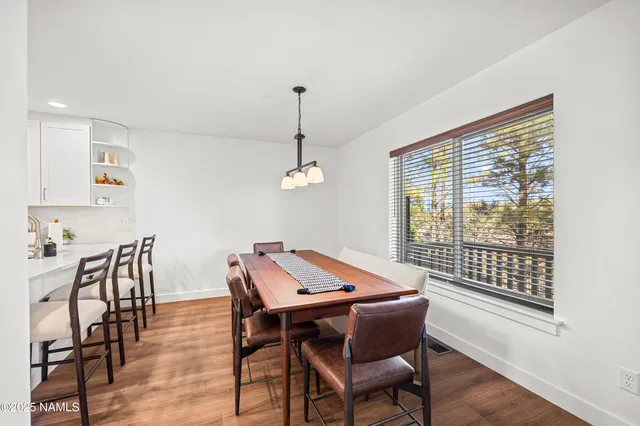 a view of a dining room with furniture window and wooden floor