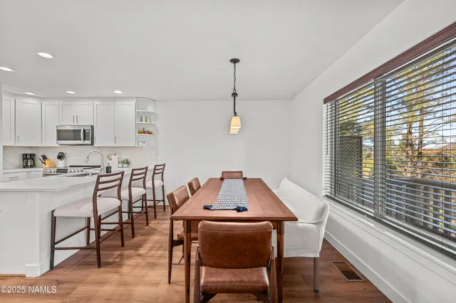 a dining room with furniture and window