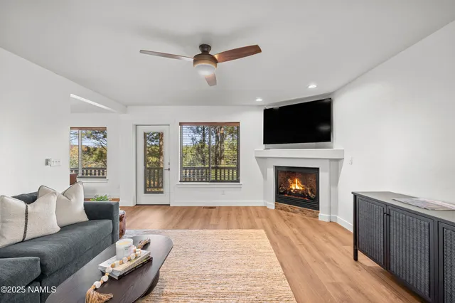a living room with furniture fireplace and flat screen tv