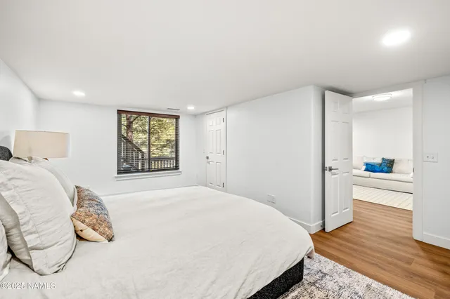 a bedroom with a bed and a window